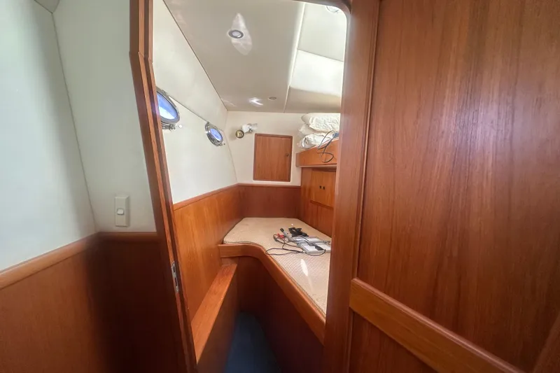 Slide: The Image of Interior cabin of 2002 Wright Catamaran C50 Pilot House, featuring wood paneling and portholes. - 11