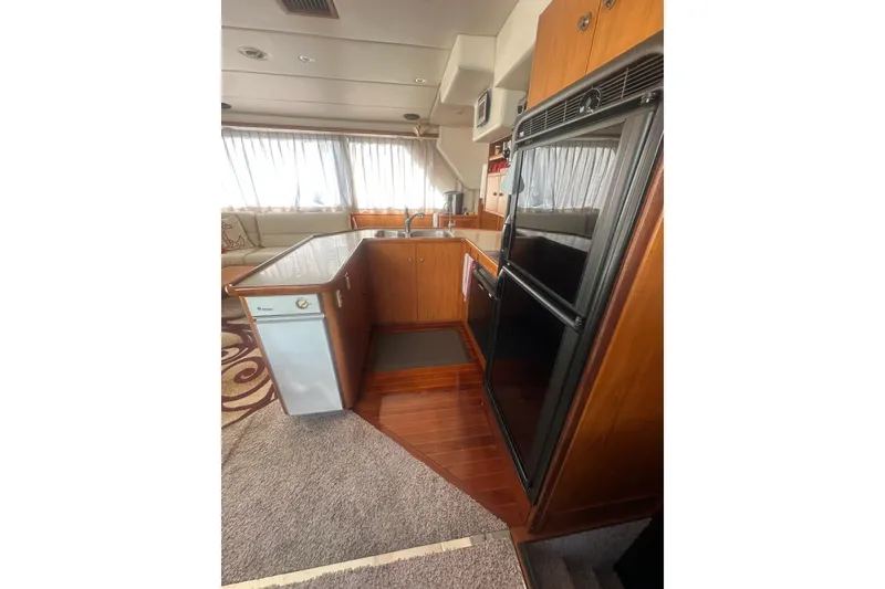 Slide: The Image of 2002 Wright Catamaran C50 kitchen with wood cabinetry, appliances, and natural light. - 21