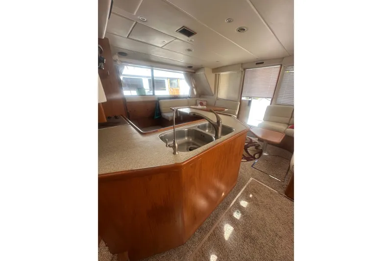 Slide: The Image of Interior of 2002 Wright Catamaran C50 Pilot House, featuring kitchen and seating area. - 23