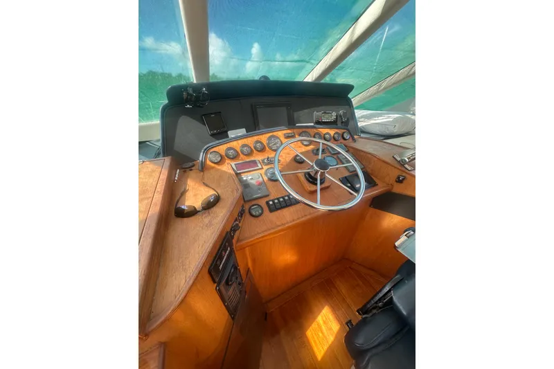 Slide: The Image of Pilot house interior of 2002 Wright Catamaran C50, featuring wooden dashboard and steering wheel. - 25