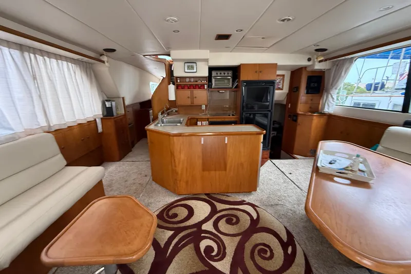 Slide: The Image of Luxurious 2001 Wright Catamaran C50 Pilot House interior with modern kitchen and seating area. - 35