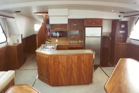 Slide: The Image of 2002 Wright Catamaran C50 Pilot House interior with wood finish and modern kitchen amenities. - 5