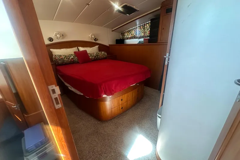 Slide: The Image of Cozy bedroom in 2002 Wright Catamaran C50 Pilot House Power Catamaran with red bedding. - 8