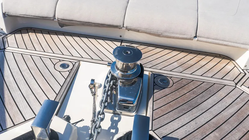 Slide: The Image of 2024 Absolute 68 NAVETTA yacht deck with winch and chain on wooden flooring. - 17
