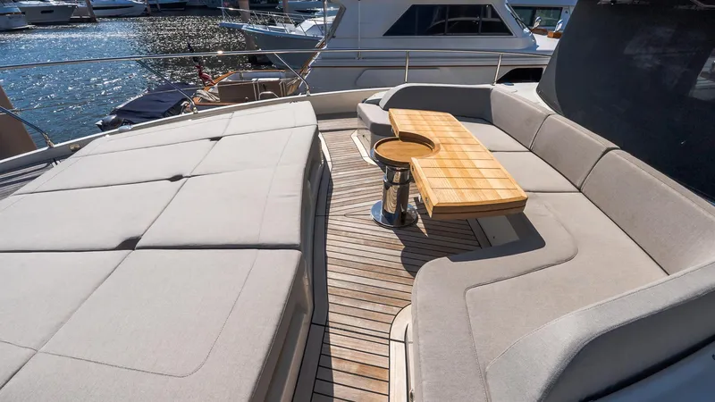 Slide: The Image of Luxurious 2024 Absolute 68 NAVETTA yacht deck with elegant seating and wooden table. - 19