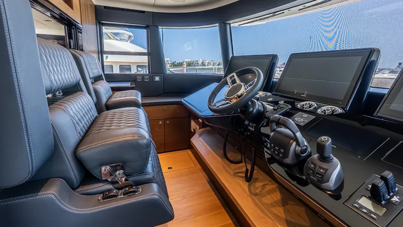 Slide: The Image of 2024 Absolute 68 NAVETTA yacht cockpit with leather seats and advanced navigation controls. - 52