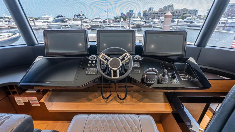 Slide: The Image of Helm of 2024 Absolute 68 NAVETTA yacht with modern navigation screens and controls. - 54