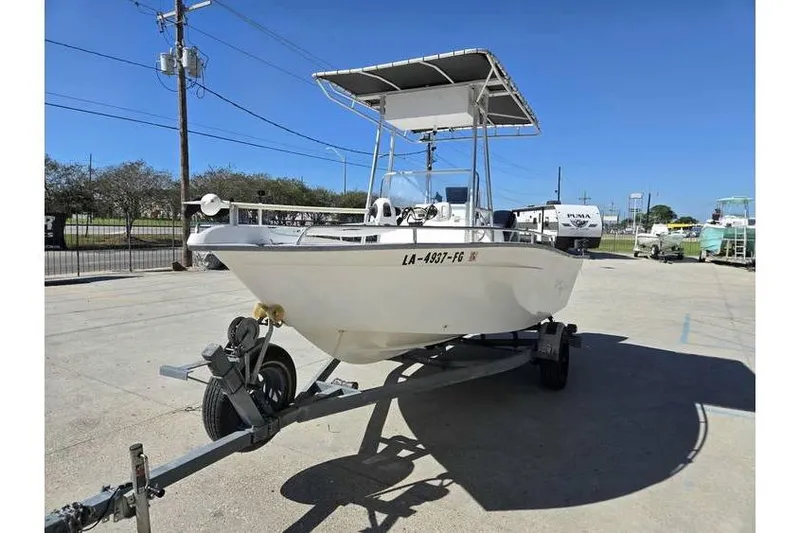 Slide: The Image of 2002 Cape Horn 17 boat on trailer, parked outdoors under clear blue sky. - 8