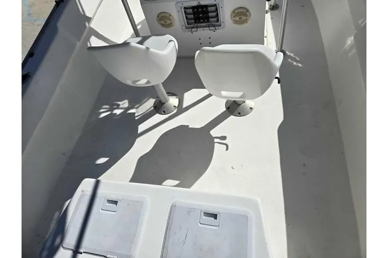 Slide: The Image of 2002 Cape Horn 17 boat interior with two white seats and console. - 3