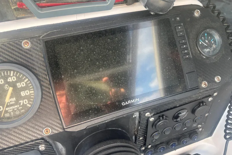 Slide: The Image of Dashboard of a 1998 Bayliner Trophy Walkaround with Garmin display and gauges. - 11