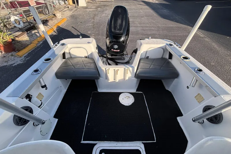 Slide: The Image of 1998 Bayliner Trophy Walkaround boat interior with seating and Suzuki outboard motor. - 18