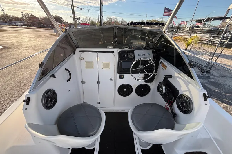 Slide: The Image of 1998 Bayliner Trophy Walkaround boat cockpit with steering wheel and Garmin navigation system. - 21