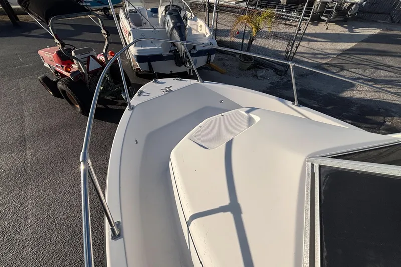 Slide: The Image of 1998 Bayliner Trophy Walkaround boat deck, parked with other vehicles. - 23