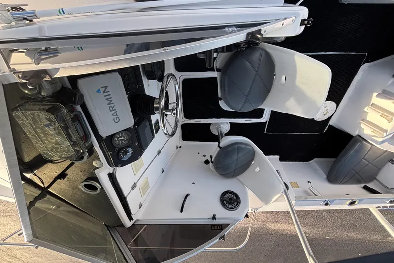 Slide: The Image of 1998 Bayliner Trophy Walkaround boat interior with Garmin navigation system and seating. - 26