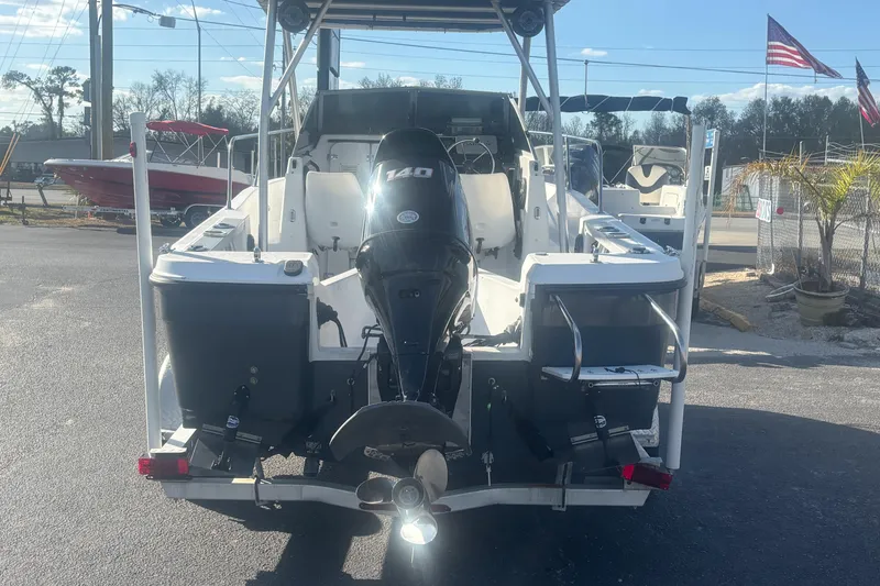 Slide: The Image of 1998 Bayliner Trophy Walkaround boat with 140 HP outboard motor, parked outdoors. - 4