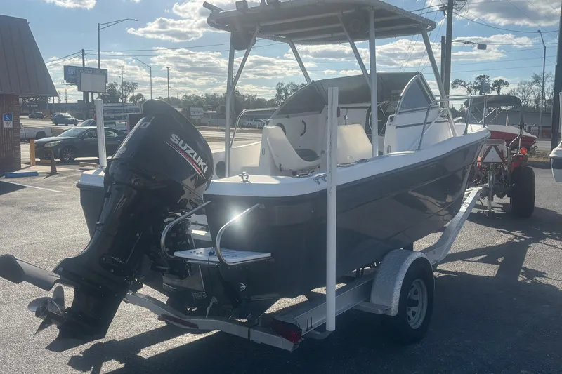 Slide: The Image of 1998 Bayliner Trophy Walkaround boat with Suzuki outboard motor on trailer. - 5