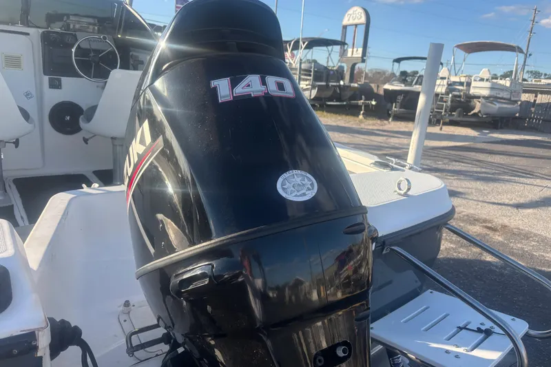 Slide: The Image of Bayliner 2002 Trophy Walkaround 1998 with Suzuki 140 outboard motor in a marina setting. - 9