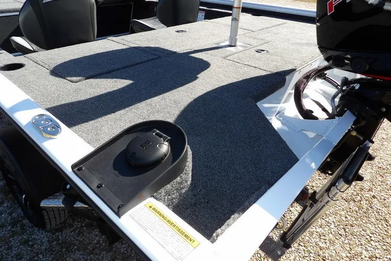 Slide: The Image of 2026 Lund 1875 Renegade boat interior with carpeted deck and motor detail. - 10