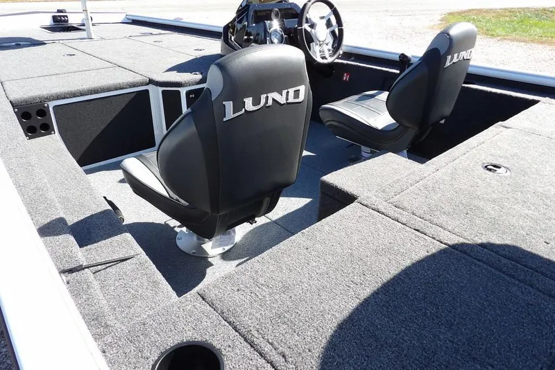 Slide: The Image of 2026 Lund 1875 Renegade boat interior with two seats and steering wheel. - 12