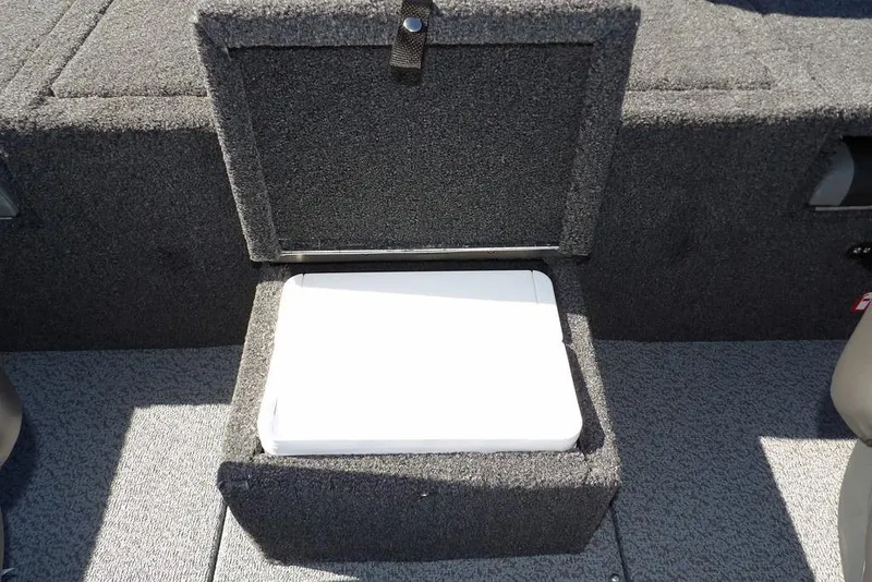 Slide: The Image of 2026 Lund 1875 Renegade boat storage compartment with open lid, revealing interior space. - 14