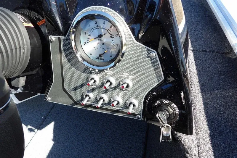 Slide: The Image of Dashboard of 2026 Lund 1875 Renegade boat with RPM gauge and control switches. - 19