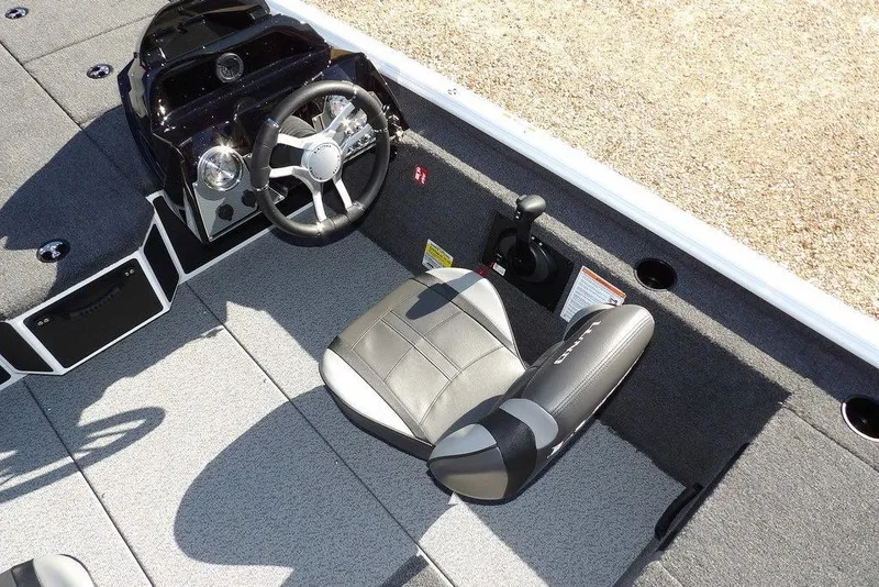 Slide: The Image of 2026 Lund 1875 Renegade boat interior with steering wheel and seat, featuring modern design. - 20