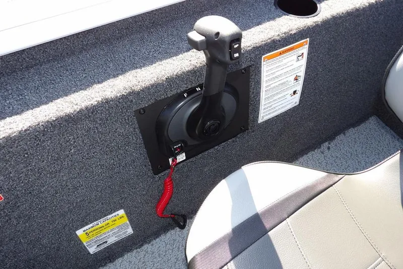 Slide: The Image of 2026 Lund 1875 Renegade boat interior with control lever and safety instructions. - 22