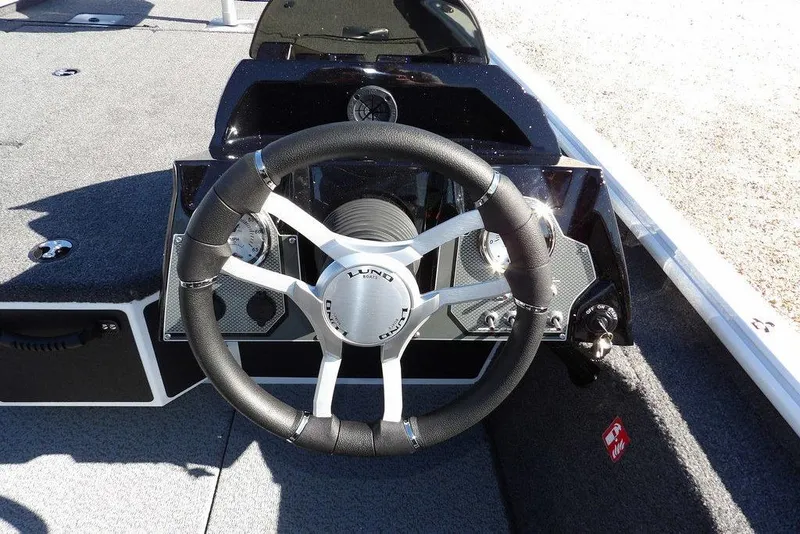 Slide: The Image of 2026 Lund 1875 Renegade boat steering wheel and dashboard close-up. - 23