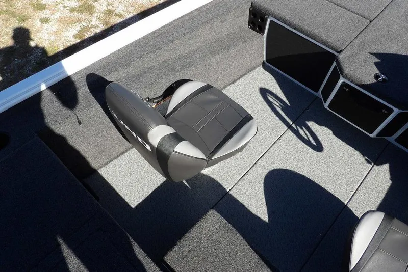 Slide: The Image of 2026 Lund 1875 Renegade boat interior with gray seating and carpeted flooring. - 25