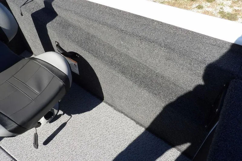 Slide: The Image of 2026 Lund 1875 Renegade boat interior with gray carpet and black seat. - 29