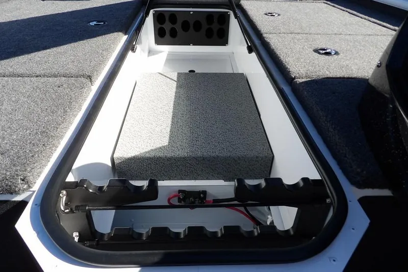 Slide: The Image of 2026 Lund 1875 Renegade boat interior storage compartment with carpeted finish. - 33