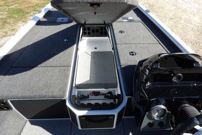 Slide: The Image of 2026 Lund 1875 Renegade boat interior with open storage compartment and motor detail. - 35