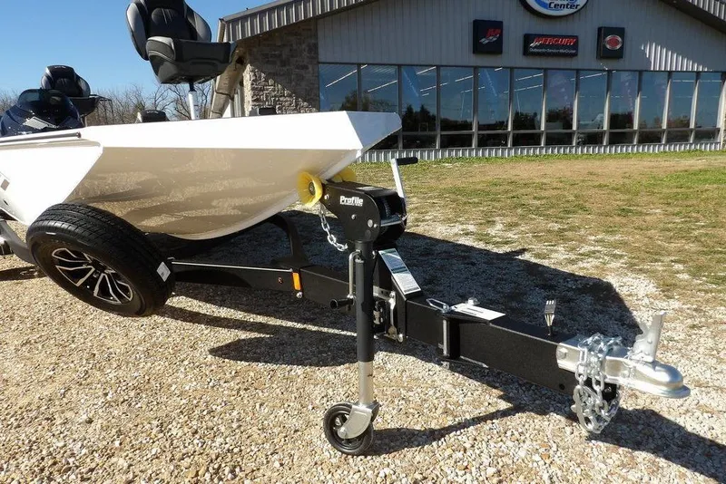 Slide: The Image of 2026 Lund 1875 Renegade boat on trailer outside dealership, showcasing modern design and features. - 38