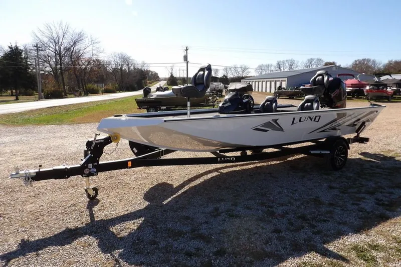 Slide: The Image of 2026 Lund 1875 Renegade boat on trailer, parked outdoors on gravel. - 5