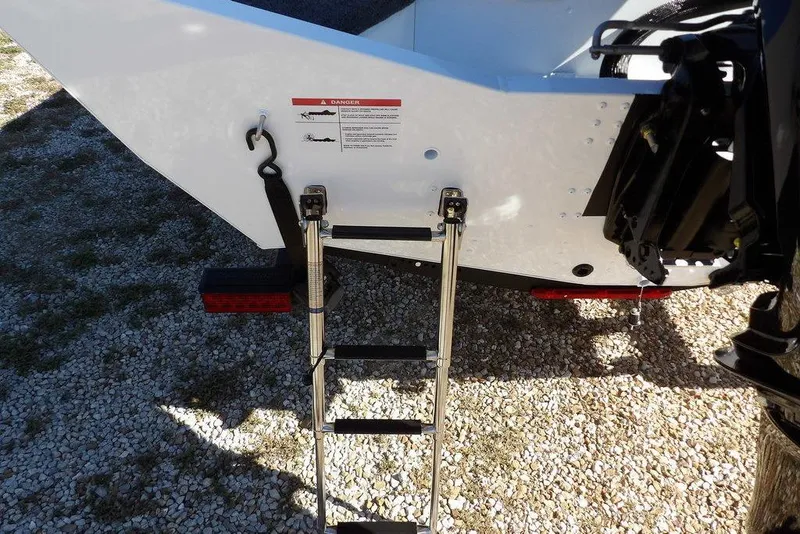 Slide: The Image of 2026 Lund 1875 Renegade boat with ladder on gravel surface. - 51