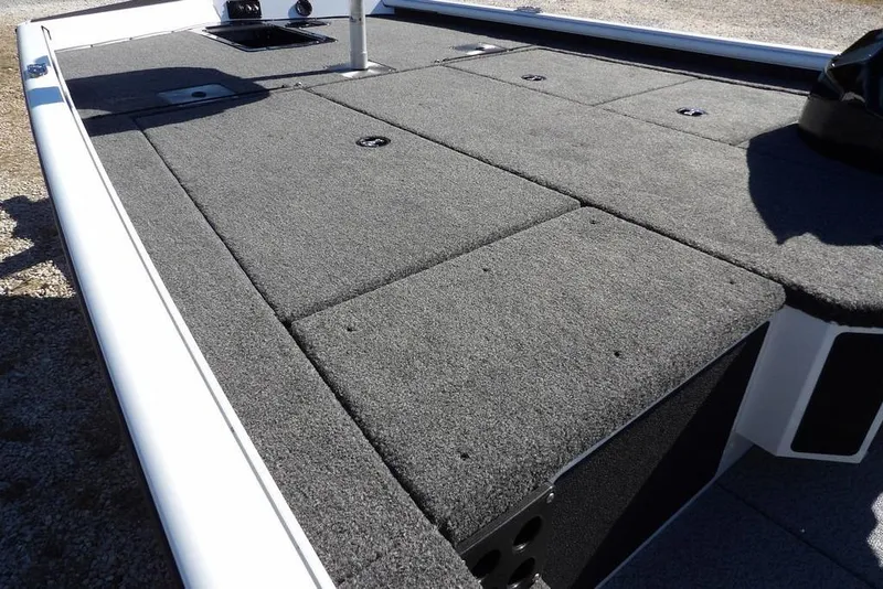 Slide: The Image of 2026 Lund 1875 Renegade boat deck with gray carpet and storage compartments. - 8