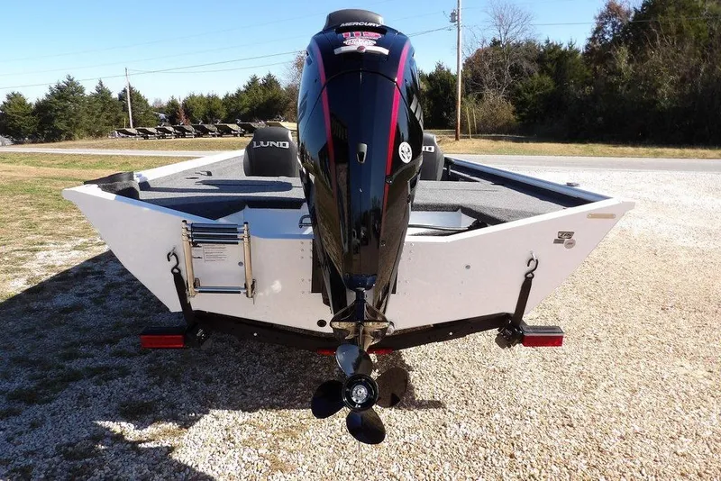 Slide: The Image of 2026 Lund 1875 Renegade boat with powerful outboard motor, parked on gravel. - 9