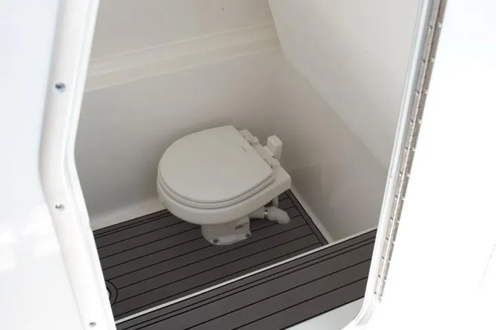 Slide: The Image of Manufacturer Provided Image: Interior view of 2026 Cape Horn 32 XS boat bathroom with toilet and sleek flooring. - 12
