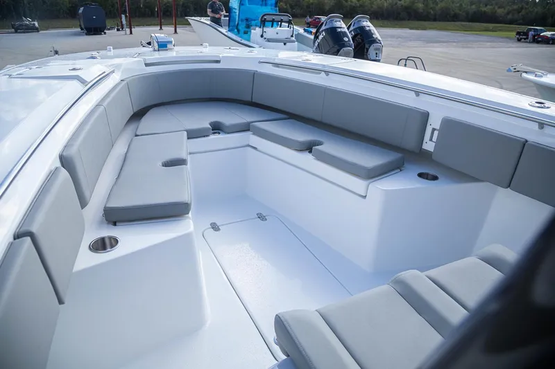 Slide: The Image of Manufacturer Provided Image: 2026 Cape Horn 32 XS boat interior with gray seating and cup holders. - 4