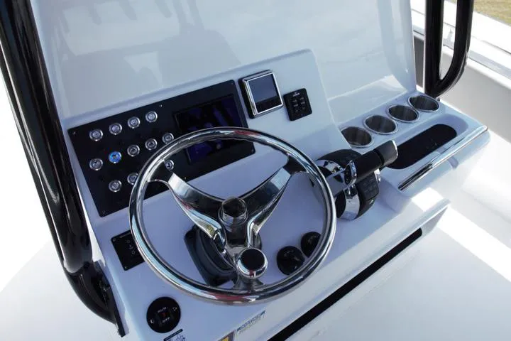 Slide: The Image of Manufacturer Provided Image: Steering console of 2026 Cape Horn 32 XS boat with modern controls and cup holders. - 7