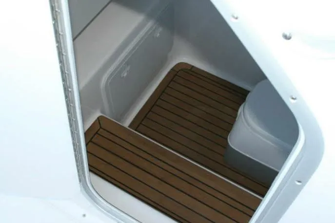 Slide: The Image of 2026 Cape Horn 32 XS boat interior with blue LED lighting and cushioned seating. - 11