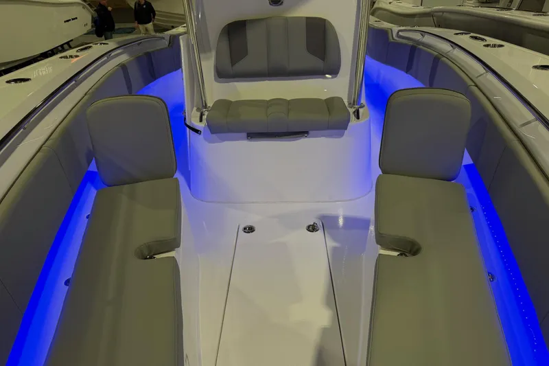 Slide: The Image of 2026 Cape Horn 32 XS boat interior with blue LED lighting and cushioned seating. - 13