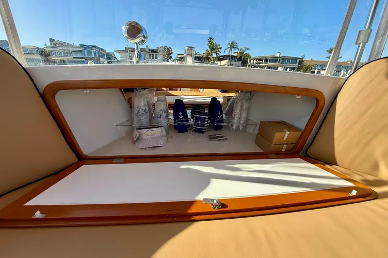 Slide: The Image of Storage compartment on 2022 Duffy Suncruiser 22 boat, featuring nautical-themed items and accessories. - 13