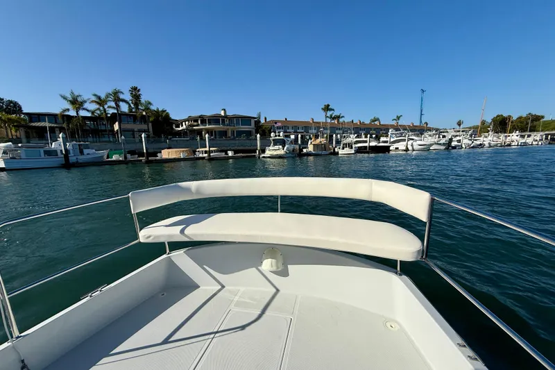 Slide: The Image of 2022 Duffy Suncruiser 22 boat on water near marina with palm trees. - 15
