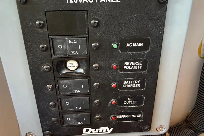Slide: The Image of 120VAC panel on 2022 Duffy Suncruiser 22 with switches and indicators. - 21