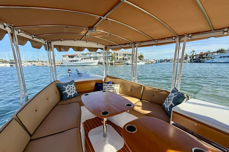 Slide: The Image of 2022 Duffy Suncruiser 22 boat interior with tan seating and waterfront view. - 4