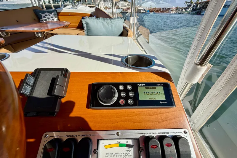 Slide: The Image of 2022 Duffy Suncruiser 22 boat interior with control panel and waterfront view. - 7