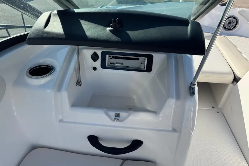 Slide: The Image of 2013 Yamaha AR192 boat dashboard with open glove compartment and cup holder. - 10