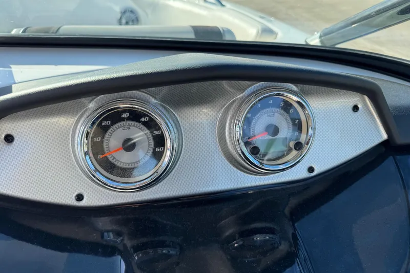 Slide: The Image of Dashboard of 2013 Yamaha Boats AR192 showing speedometer and tachometer gauges. - 12