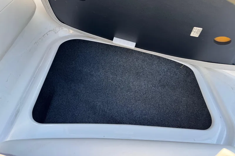 Slide: The Image of 2013 Yamaha Boats AR192 storage compartment with carpeted interior. - 18